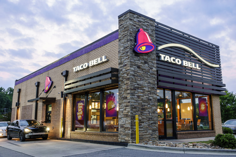 Gastonia, North Carolina, Taco Bell Mexican fast food restaurant and drive thru at dusk